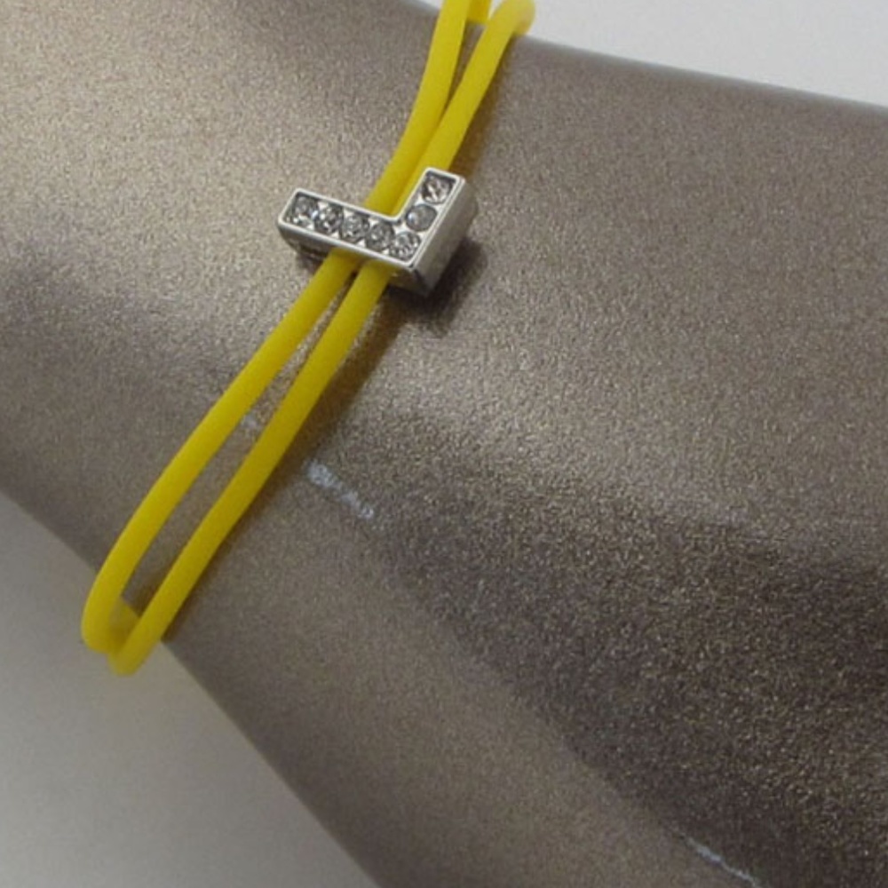 Multi colored rubber bracelets w/charm letters that spell out LOVE